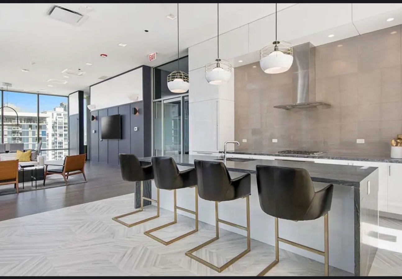 Condo kitchen dark stone waterfall island Chicago