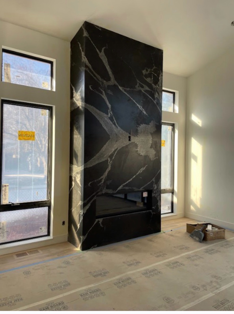 Black marble fireplace surround freshly installed Chicago
