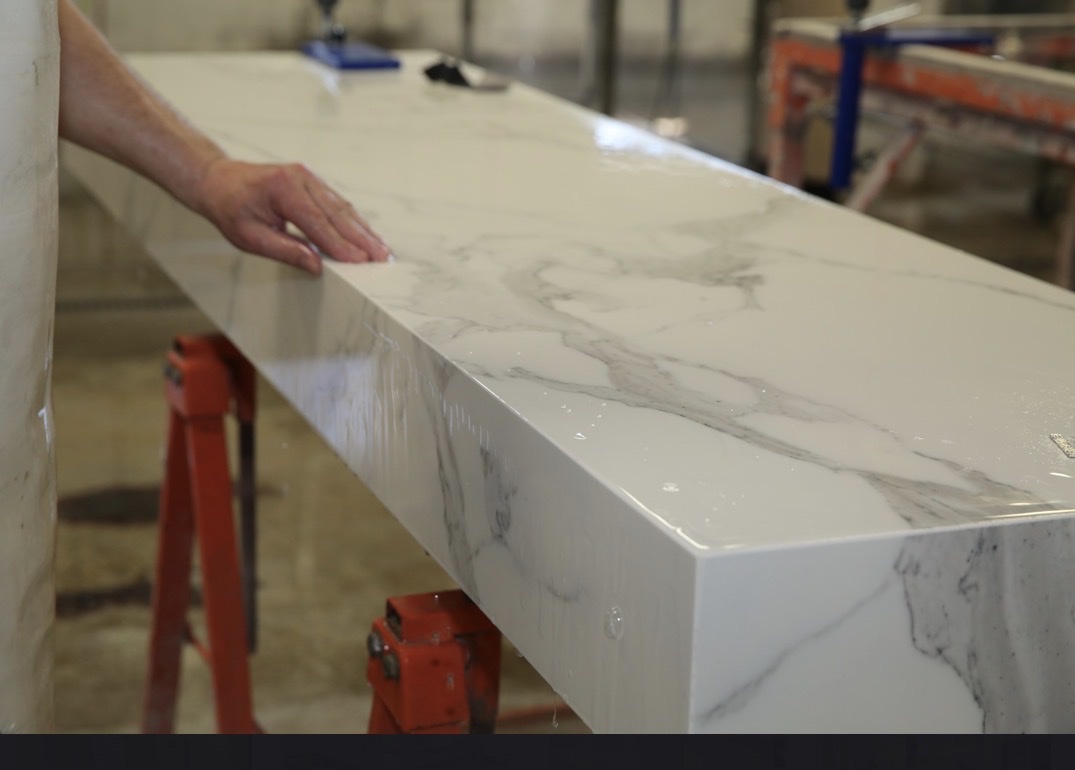 Hands checking marble edge in fabrication shop Franklin Park