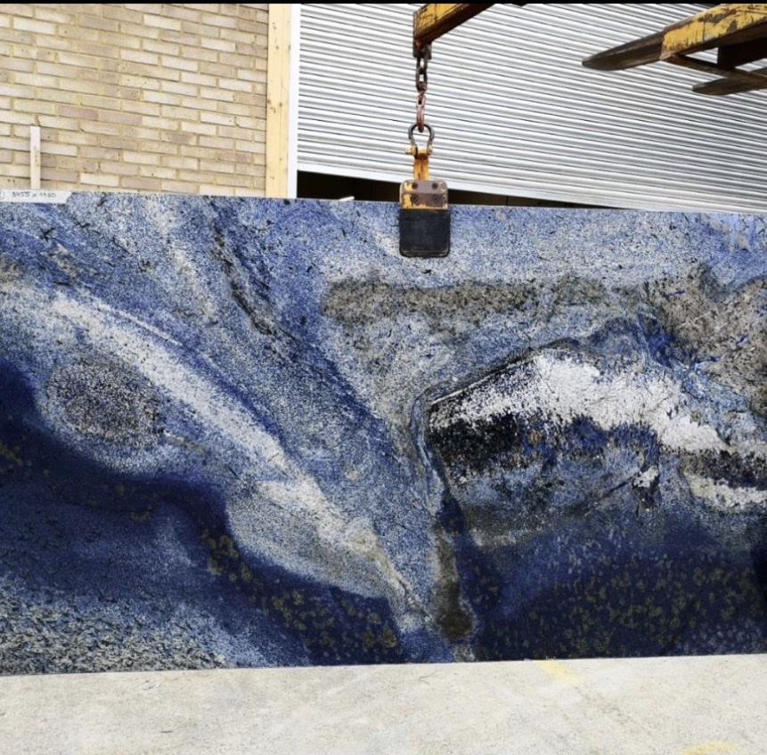 Rare blue Sodalite granite slab being lifted at warehouse Chicago